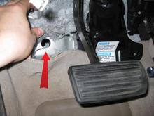 This is a shot of the firewall location where I ran the 4g power wire.  When researching running through the firewall I noticed everyone was having a lot of difficulty with it.  So, I figure posting this may help someone.  Instead of drilling holes, simply locate this stock opening.  Through this opening the wire doesn't go straight into the engine bay, but rather it goes into a frame rail and after a few inches exits to the right into the engine bay.  The hole on the engine bay side is slightly smaller, so anything larger than 4g may not clear it with room for a rubber grommet.  The wire in the photo is just the wire used to fish the 4g wire.