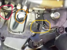 The red circle is the spring I'm referencing, this picture is from the video but mine was in the same place. 

If I move the spring down over the tab circled in yellow, you can't shift the quad at all because the spring gets caught on the stopper marked in orange. 

If I go below it the spring just falls, and I already know going above it all is incorrect, so what should I do? Hahah thanks again.