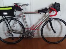 It now has smallish panniers and the front bag is being lowered to just above the caliper.  The headset, Cinelli stem and bar are all being replaced with an innicycle adapter, modern stem and 31.8 bar.  With the bag now down in front of the head tube, a Garmin Varia headlight will be used, with the Garmin GPS being mounted over that, on the same mount.  I have yet to figure out a taillight choice with the panniers and trunk bag.  It's very light without the bags.  I've also converted to Shimano