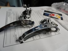 New derailleur on the left, with complete assembly for the cable clamp.  The one on the right had damaged threads for the cable clamp and needs to be re-tapped for a new fixing bolt.  A transplant will happen before sending out.