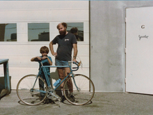 Hugh with his son and one of his bikes, in front of his Jevelot shop