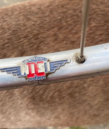 Not a sticker, but a badge that I would suspect could throw off the weight balance 