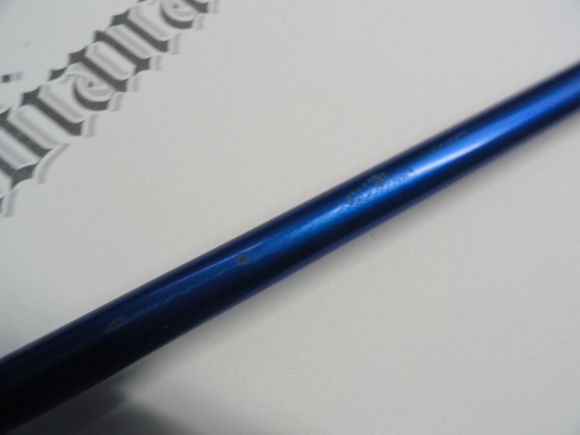 The paint is scratched down to the CF which is a black color underneath the paint.  There is no damage to the carbon fiber. The paint removal does not damage the fibers underneath.