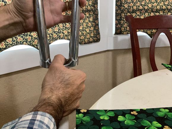 I am a lefty, so you may want to switch hands. This is what I mean by hold it vertically. The lower hand’s job is to keep everything snug. The upper hand grips the fork legs and is the hand that you apply downward force with. 