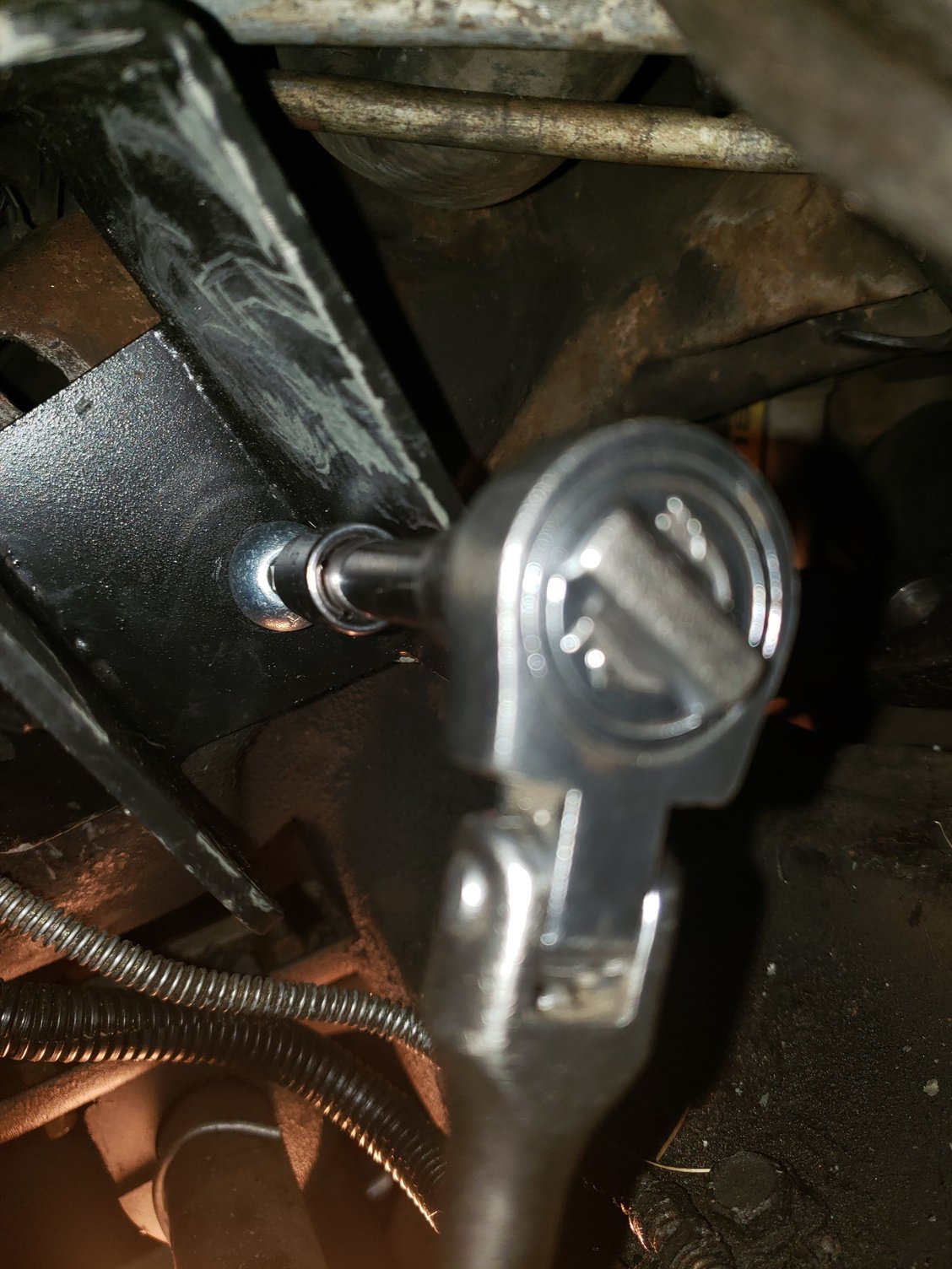 Installing the bolt for the bracket that is behind the pivot using the 8mm Allen head socket.