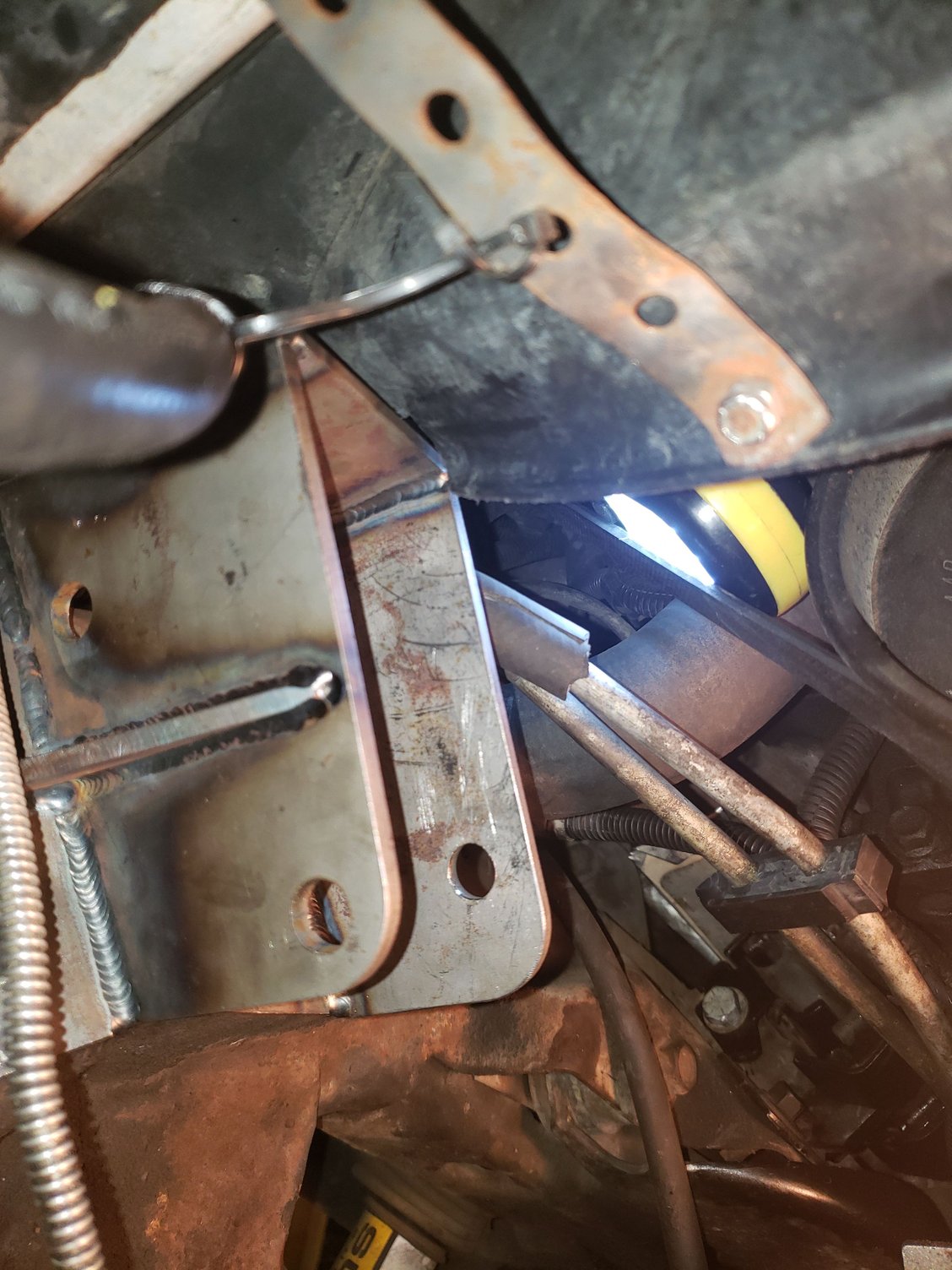 Another view of the fan shroud, its cutout and the idler arm bracket.