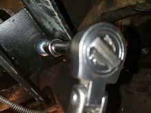 Installing the bolt for the bracket that is behind the pivot using the 8mm Allen head socket.