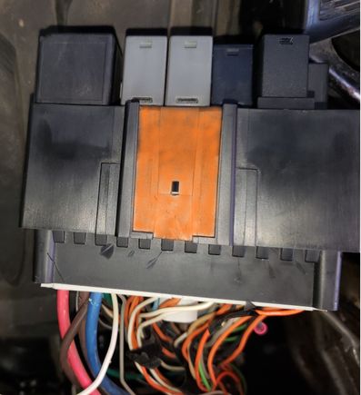 Where the tab on the bracket inserts (from the top of the BRB) highlighted in orange. The engagement tooth is unhighlighted in the middle of the highlighted area.