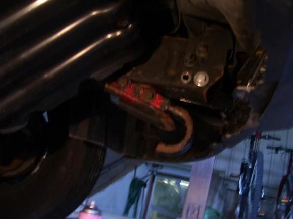 hooks off a 79 GM, drilled/bolted to the so-called car bumper "grabbers" under the rails