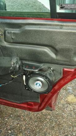 Rear right door. 6 inch or 6.5 fits. This is a cheap 6 inch Phoenix Gold Octane 6 inch speaker. Not very impressive sound.