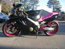 This is how it looks now. Powdercoated the wheels, front and rear foot pegs, repainted the farings. My wife rewraped the seat. More Pics coming as soon as we get the rest of the stickers, which will be pink chrome.