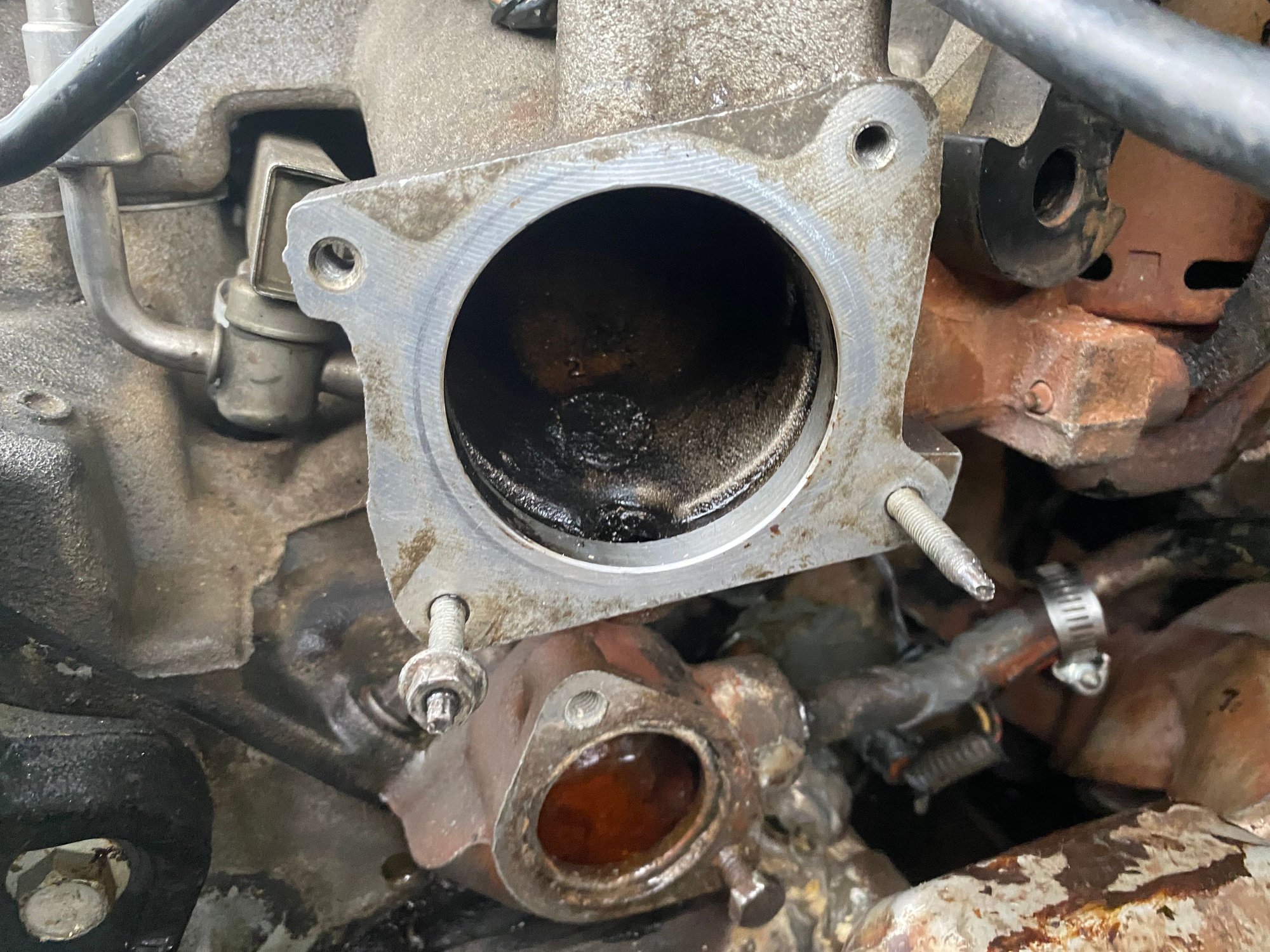 After removing throttle body from the top and the thermostat housing from the bottom, I was able to see the leak clearly when I noticed the play in the pipe. 