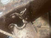 Frame damage found on passenger side in front of leaf spring hanger.