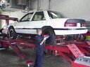 My Corsica getting a wheel alignment at The Firestone Auto repaire store, located by the Eola &amp; New York street intersection in Aurora IL 60504. Showing the area in back that was painted semi-gloss black.
