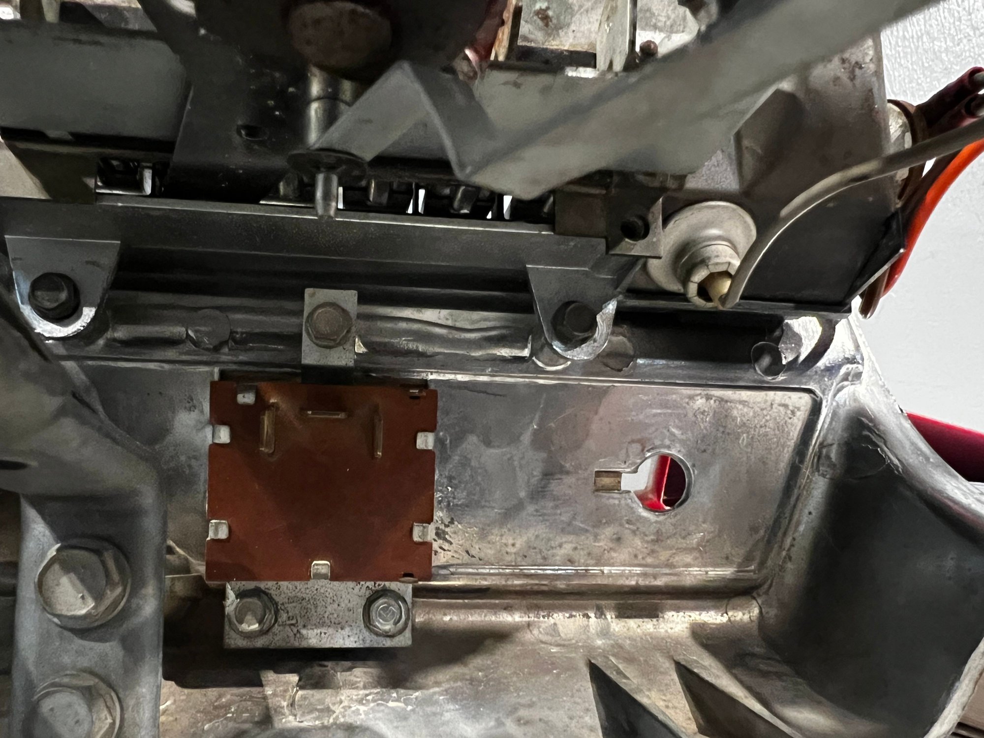 This is the underside of the heater/AC control, showing two of the attaching bolts (black, left center and slightly right center). There is one on the top side I accessed from the top while these could only be removed from underneath