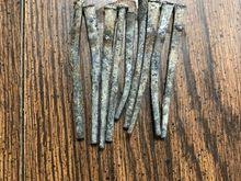 These nails are a minimum of 93 yrs of age. These are the type of solid lead nails used in the building industry during (at least prior to ~1935). They're still in excellent condition. No - I am not reusing them.