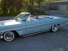 Powder blue primer with &quot;old school&quot; scallops on hood, fenders, and deck lid.  White wall tires, shaved door handles, shaved reverse lights.  Top was chopped after 2nd owner busted the rear windshield.  All body customizing done by a junior college body shop instructor.  Very little surface rust, very solid car.