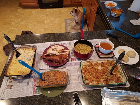 Upper Left - Lower Right:  Cheesy shredded potatoes; Turkey; stuffing; gravy; homemade yeast rolls; sweet potato casserole; green bean casserole 