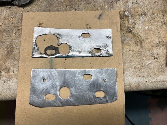 I carefully fabricated a replacement patch from some 22ga. sheetmetal.  It was very difficult to cut the slots and the large hole as the think sheetmetal wanted to bend & twist.  What you see here is actually my second attempt.