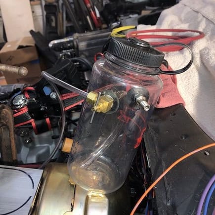 Close-up pic of the sport bottle; the pet cock has a short section of tubing that must remain submerged in brake fluid or else you'll push air into the master cylinder.  Fill the bottle about 1/2 full leaving 1/2 the bottle to fill with pressurized air.  The bottle cap must be tightly sealed to prevent the pressurized air from escaping.