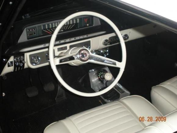 Original radio and 4-speed console with tachometer.