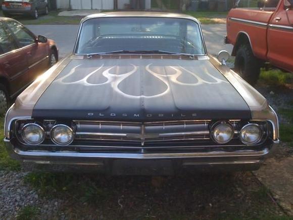 This is after the hood was installed I stripped it in the basement and painted it with rattle cans. Satin black with an Oldsmobile gold flames.