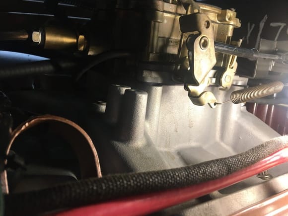 Leak is below the throttle and front part of spring down the manifold side (light stains)