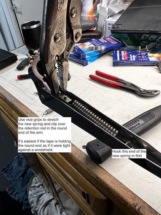 Use your small vice grips to stretch the spring and hook the clip over the bar in the mounting end of the wiper blade.