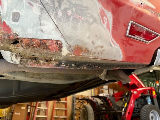 Grinding out spot welds behind the tire area.  Marked them with a black marker to make them easier to see