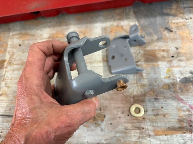 Bottom hinge with roller detent.  It uses one small and one large bushing.  They are a mild press fit