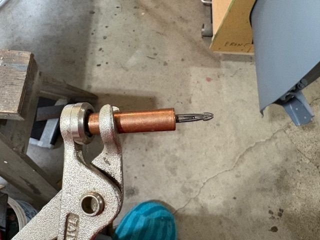 A Cleco in the extended position narrows the barbed end, making it possible to fit through a 1/8” hole