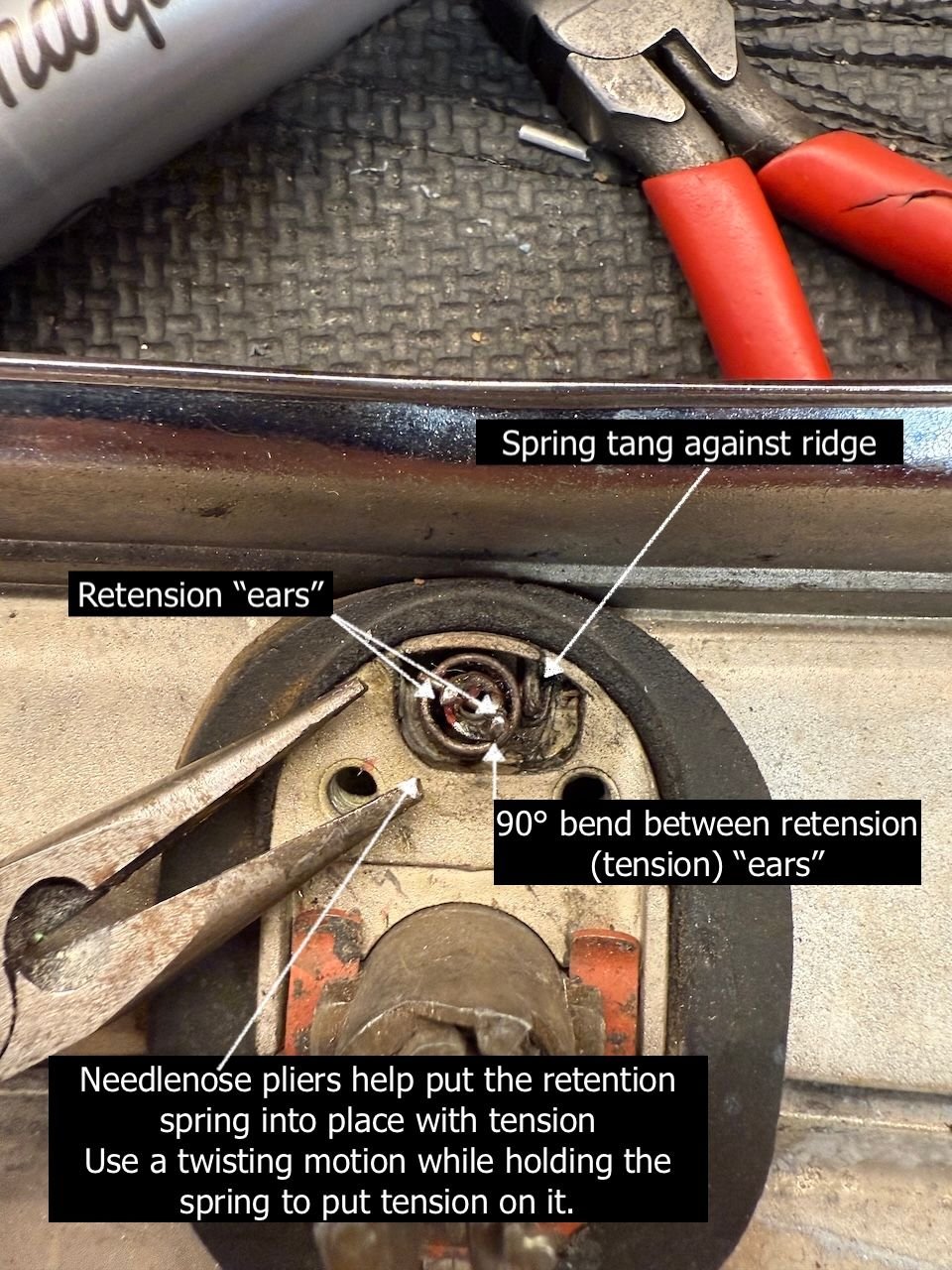 The pliers can be used to pull or twist the spring into position between the notches. This is a pain, especially with modified parts. Use the smallest pliers you have and have a tiny screwdriver on hand to push the spring while you are holding the pliers. It�s a 3 hand job.