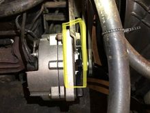 Where the upper bolt passes through: when tightened the alternator tweaks  the unused hole towards the front of the truck. 
