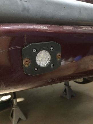 Here is the driver side light. I used black oxide bolts which was obviously a mistake. I will get around to replacing them one of these days. The red plastic is not very tight against the gray metal, so I used some washers in between the plastic and the metal to keep the bolts from sucking the plastic in in one spot.