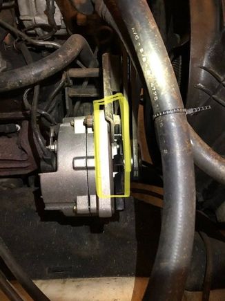 Where the upper bolt passes through: when tightened the alternator tweaks  the unused hole towards the front of the truck. 