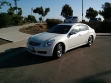 Infiniti G35X Exterior Trim detailed.         
	Body color shown on front fender
	Chrome/bright trim around side windows.
	Driver side shows clear bra protection on painted surfaces of fenders, hood, and door mirrors