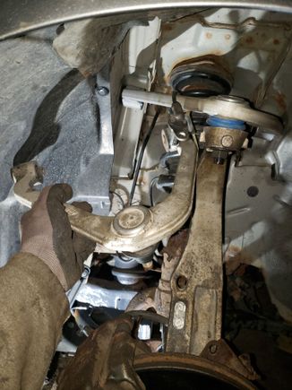 New upper control arm next to old one.