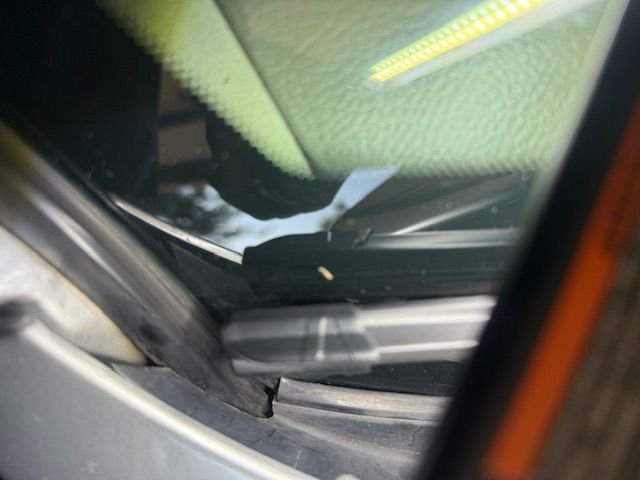 Corner of windshield and plastic cowl, near the hood has a gap that leads directly into the wiring in Pic1.