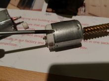 Slide the screwdriver into the hole to remove the metal latch.  Just remove 1 side, so that it holds better when we re-assemble