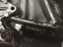 Oil pan bolt with nut on it replacing stripped thread on one oil pan spot.