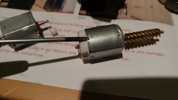 Slide the screwdriver into the hole to remove the metal latch.  Just remove 1 side, so that it holds better when we re-assemble