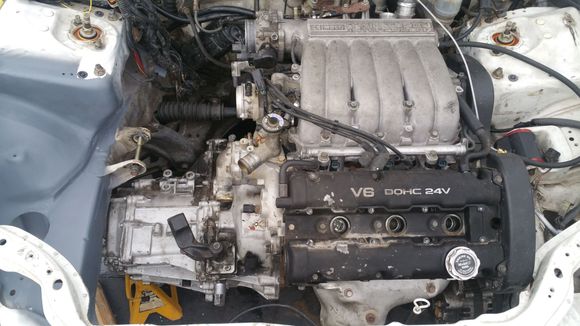 Pulled out the 5sp FWD, mounted up the 6sp AWD and started cleaning up the engine bay. Still the N/A dodge stealth engine inside, the TT block still sitting on the engine stand, not installing until the car is ready.