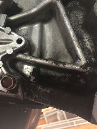 Oil pan bolt with nut on it replacing stripped thread on one oil pan spot.