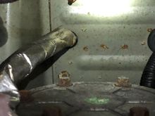 This is directly under the parking brake. Close up to help show that drips are forming at the ends of the bolts.