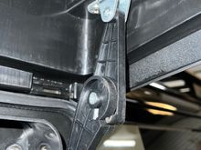 This is the hinge that locks open to hold the lid open. Although it's plastic, its relatively tight and does the job. I've heard that the OEM isn't much better, but can't comment on that myself.