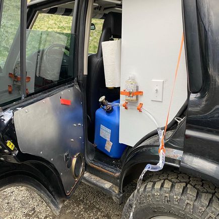 Sink/wash station with fold-out spout. Runs off a 12V air compressor, VW washer style