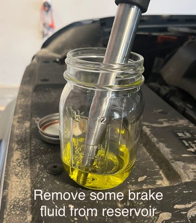 Remove fluid to prevent overflow 