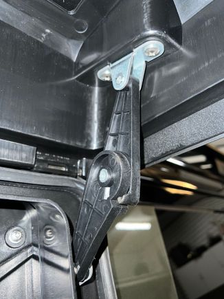 This is the hinge that locks open to hold the lid open. Although it's plastic, its relatively tight and does the job. I've heard that the OEM isn't much better, but can't comment on that myself.