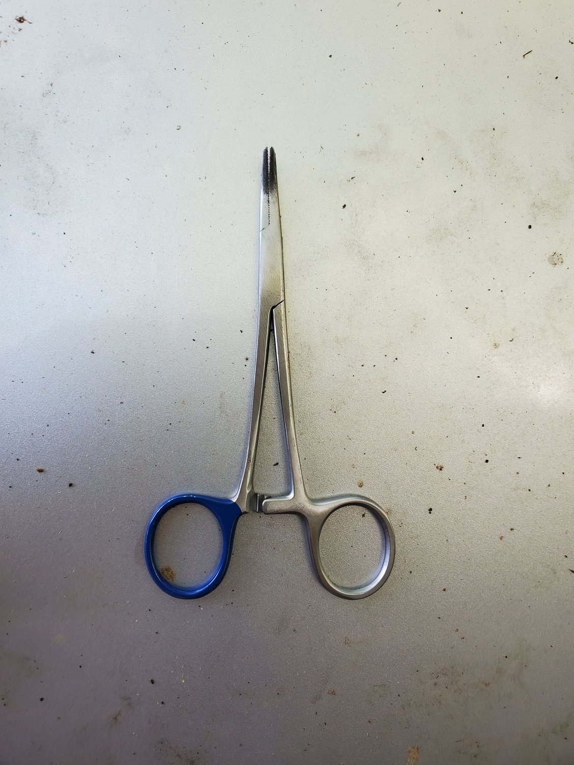 I used some hemostats to squeeze the ears of the clip till they bend strait.