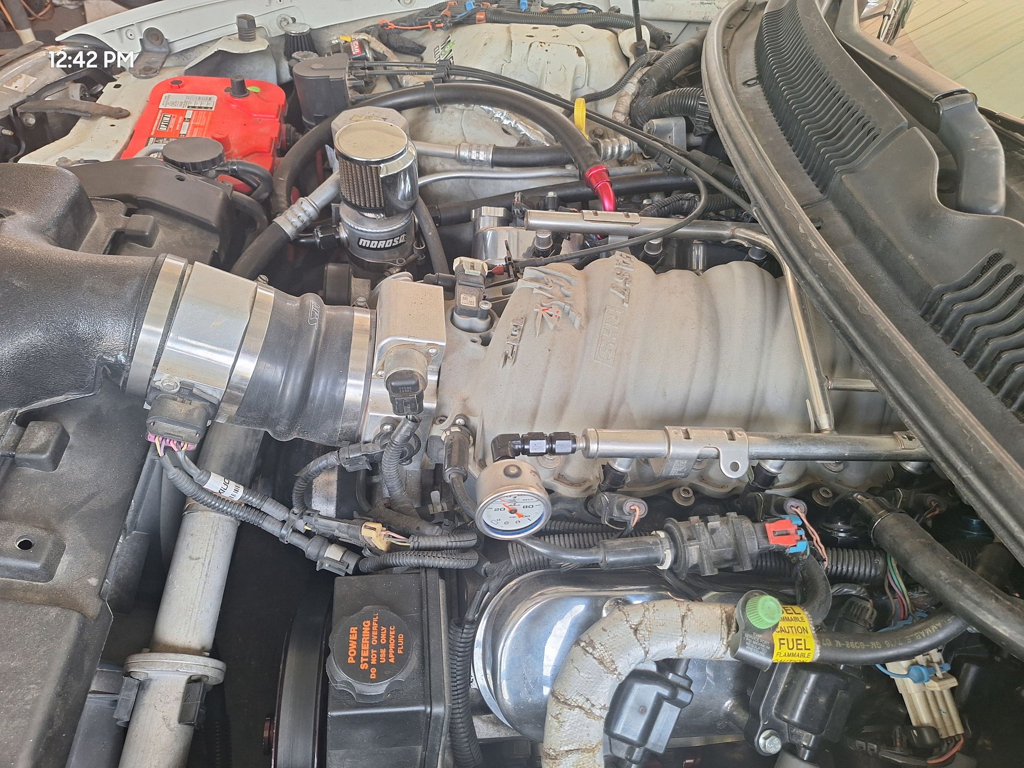 Notice the 10AN on the passenger and the other 10AN line on the drivers side valve covers? Those both connect to the Moroso breather can shown in the image. As for the intake manifold and throttle body they are capped off.